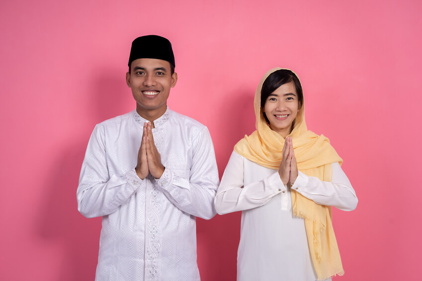 conservative muslim couple smiling into camera