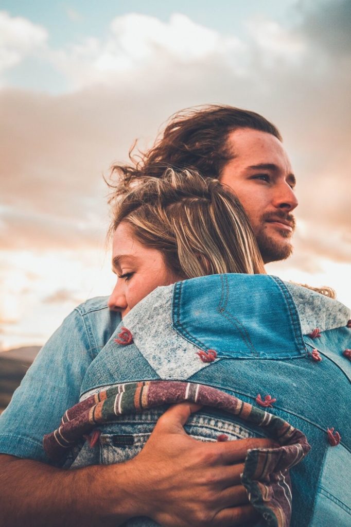 A couple hugging each other after an argument