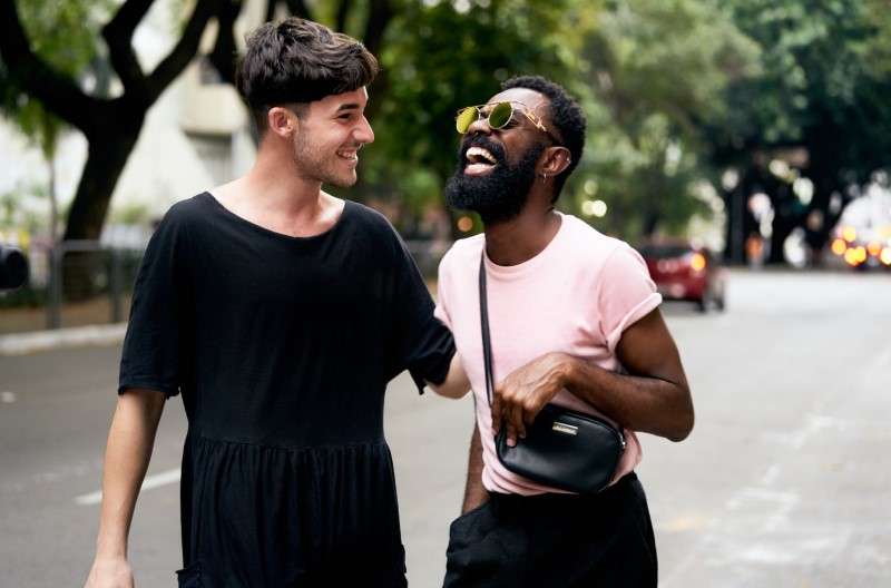 two men laughing together on the street